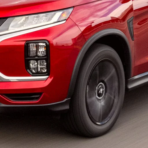 Front right headlight of Red Mitsubishi