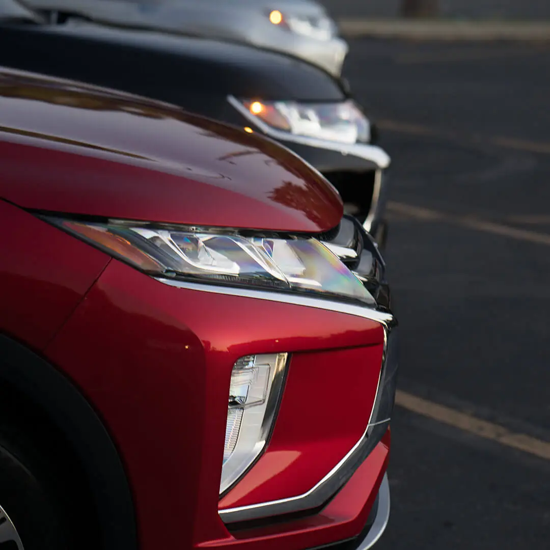 Side view of a line of new Mitsubishi vehicles